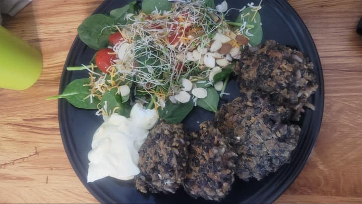 Black bean patties and side salad on a plate.
