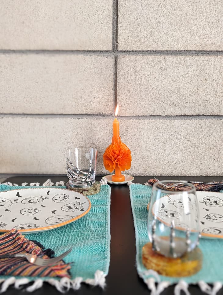 Mexican floral taper candle on dining room table.