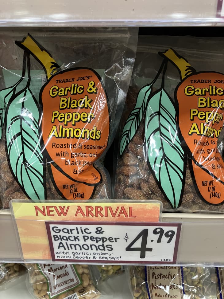 garlic and black pepper almonds on shelf with new arrival sticker