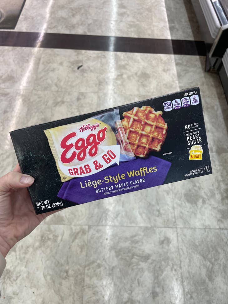 Someone holding package of Kellogg's Eggo Grab and Go Liege Style waffles.