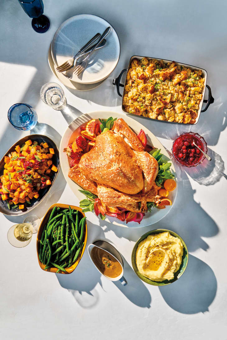 Thanksgiving turkey surrounded by side dishes.