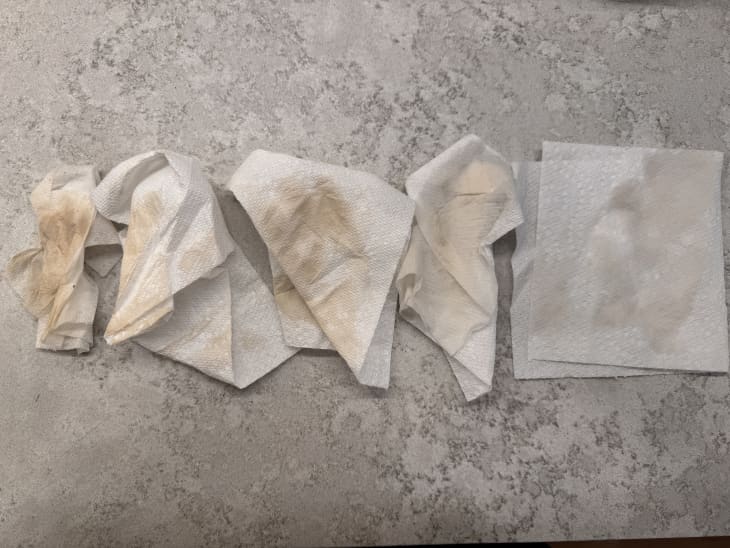 photo of dirty paper towels and one cleaner one on cement surface