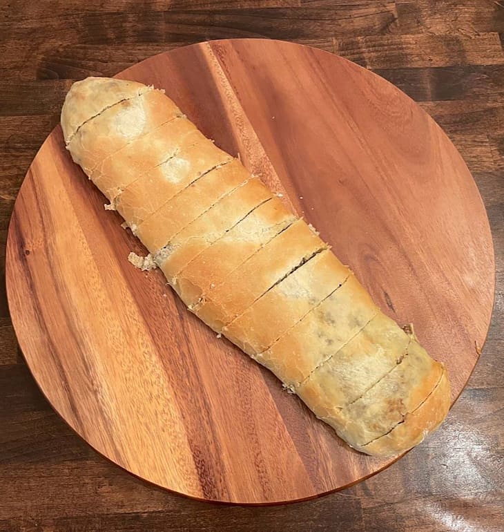 Sausage roll on cutting board.