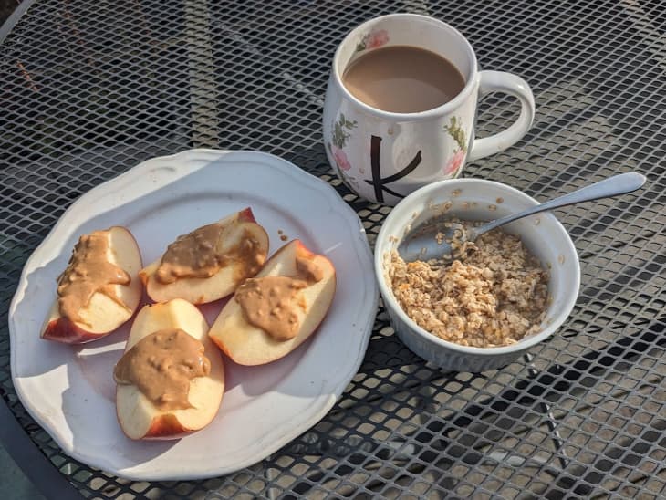 apple slices with peanut butter, cup of coffee, bowl of oatmeal