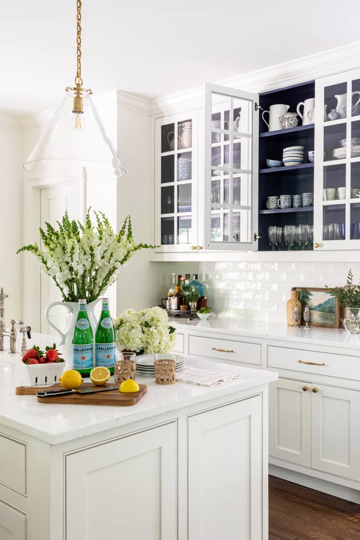 White kitchen with navy blue painted cabinet interiors