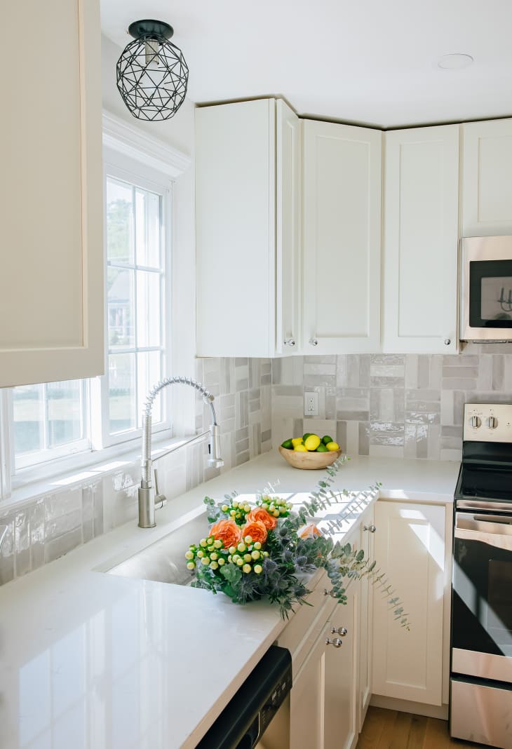 White kitchen with tile backsplash in a variety of grays