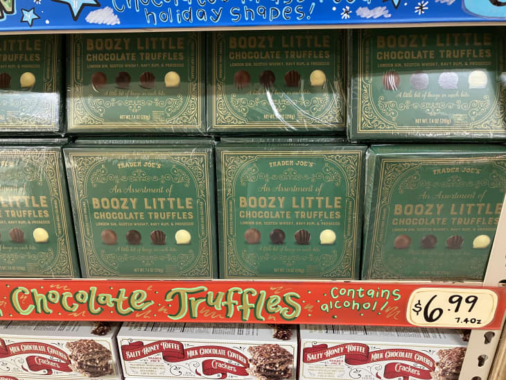green boxes of chocolate truffles on shelf with price tag