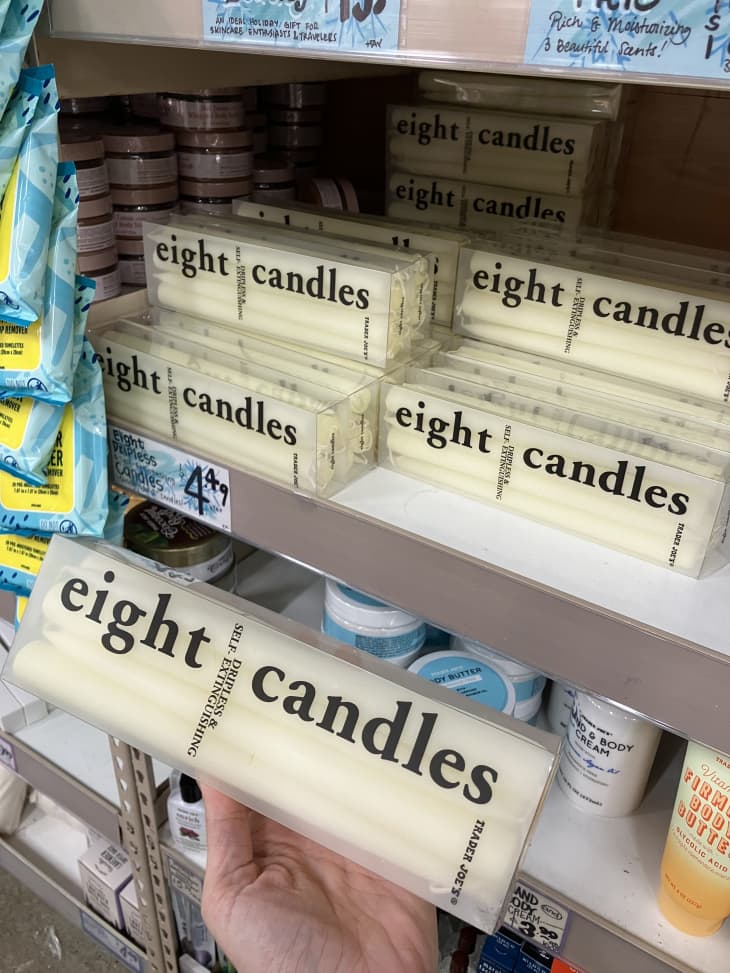 eight candles in clear box on shelf with price tag