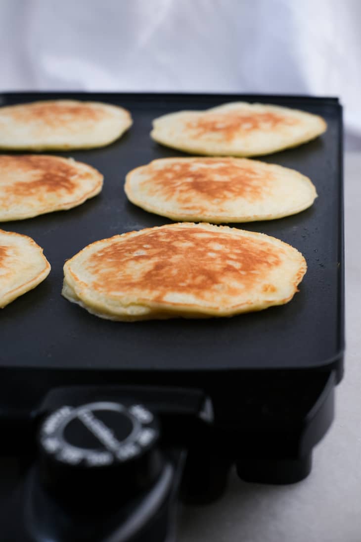The Rock's coconut banana pancakes on a griddle