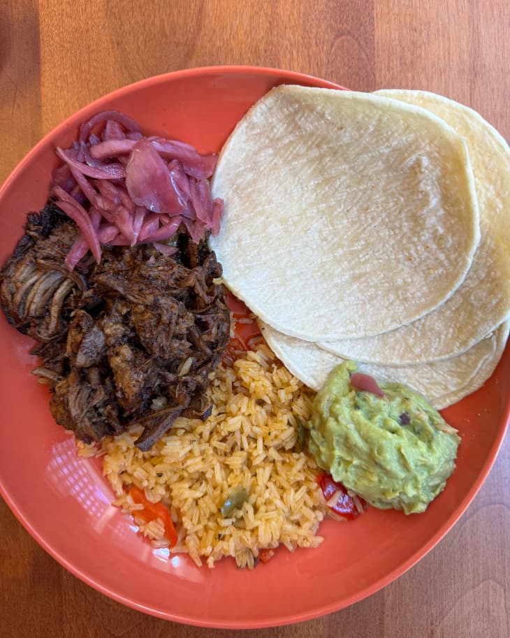 Cook Unity meal of beef, rice, guacamole and tortillas on a plate.