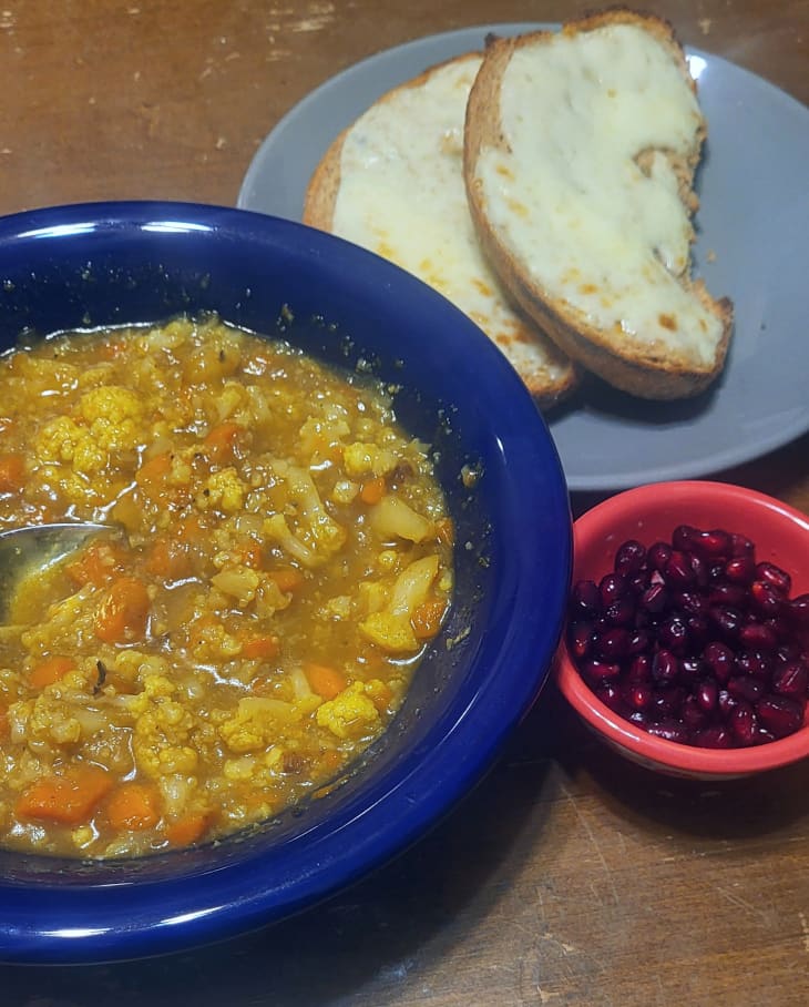 Cauliflower Soup with Cheesy Toast, and Cheese Slices with a small bowl of pomegranate seeds