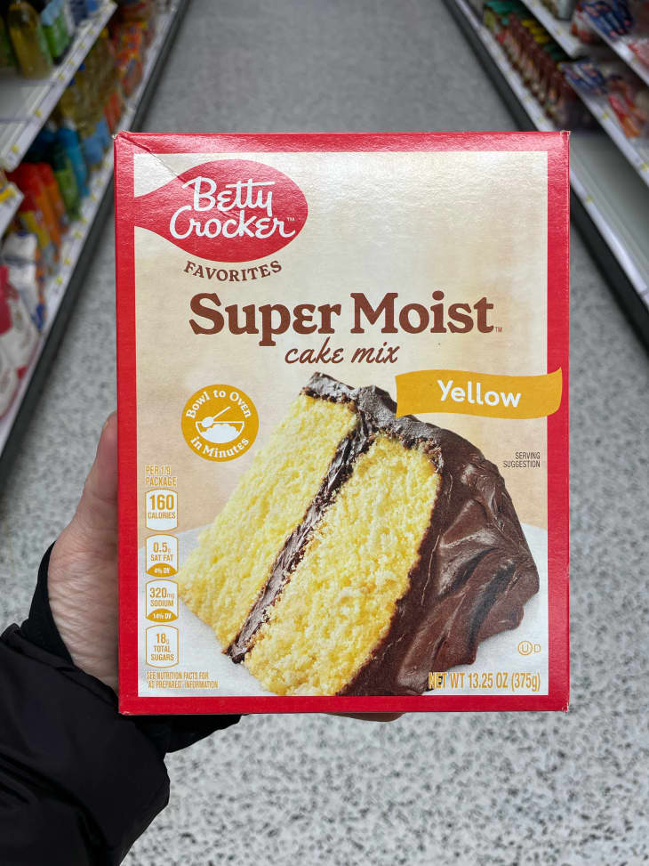 Someone holding Betty Crocker boxed yellow cake.