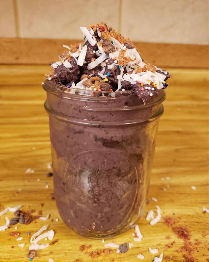 jar with homemade protein pudding with sprinkles and coconut shavings