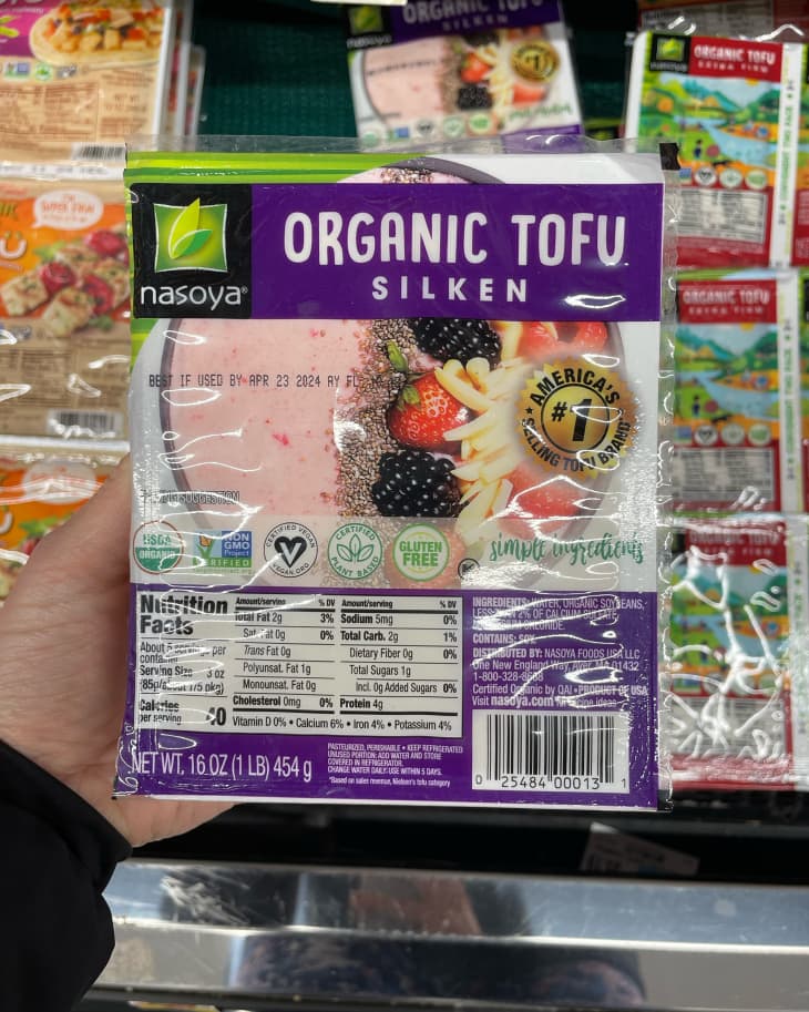 Someone holding silken tofu.