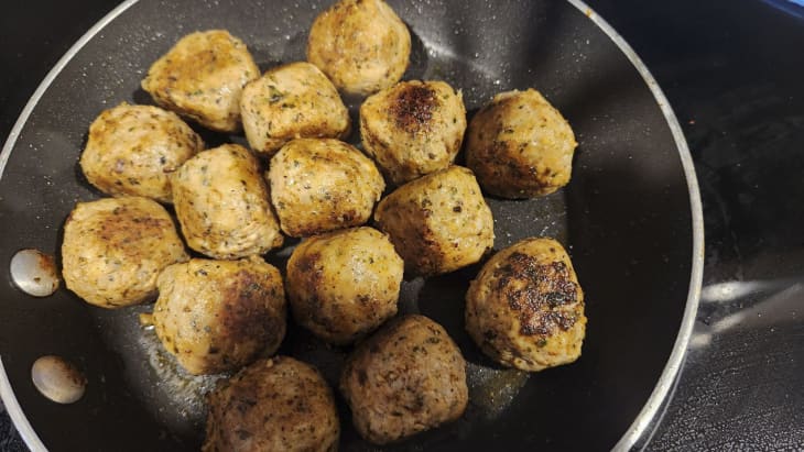 Chicken meatballs being cooked up.