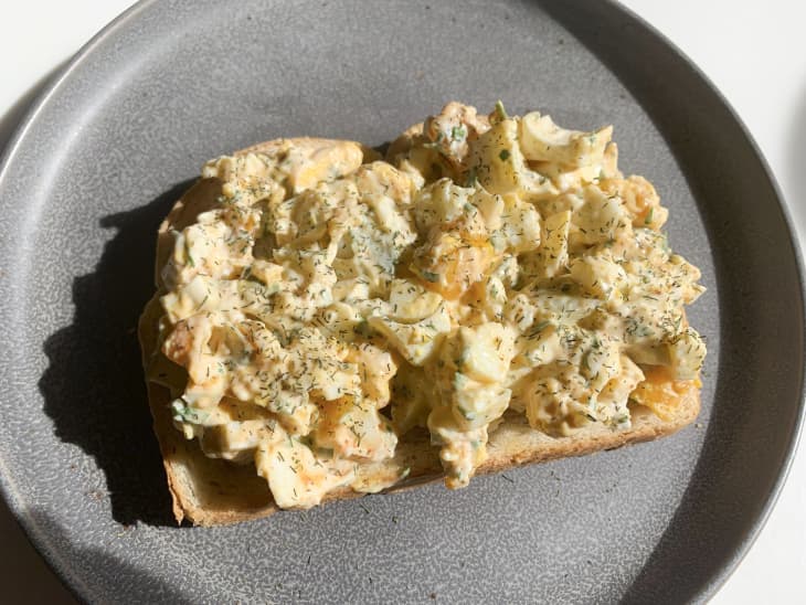 Egg salad on a piece of bread.