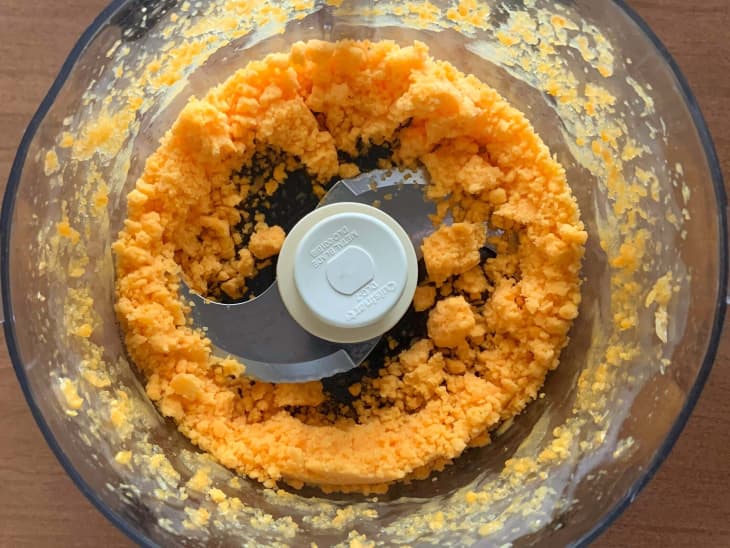 Tangerine in a food processor during processing