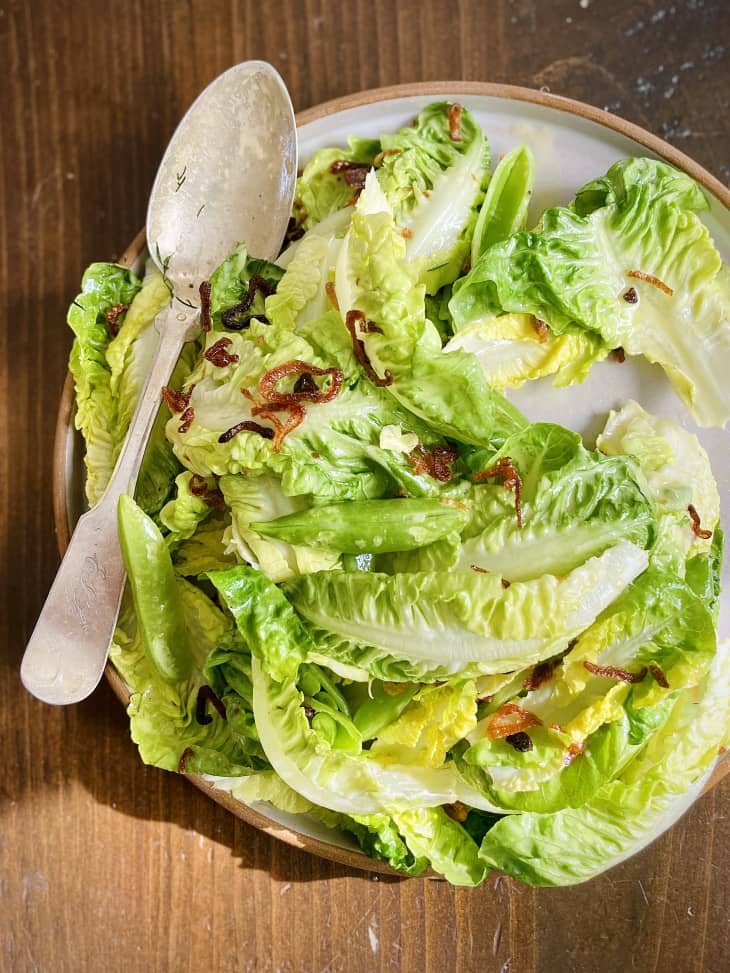 Green salad with spoon and fried shallots