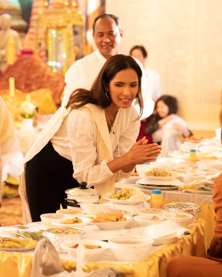 Padma Lakshmi bowing to a Monk in Taste the Nation