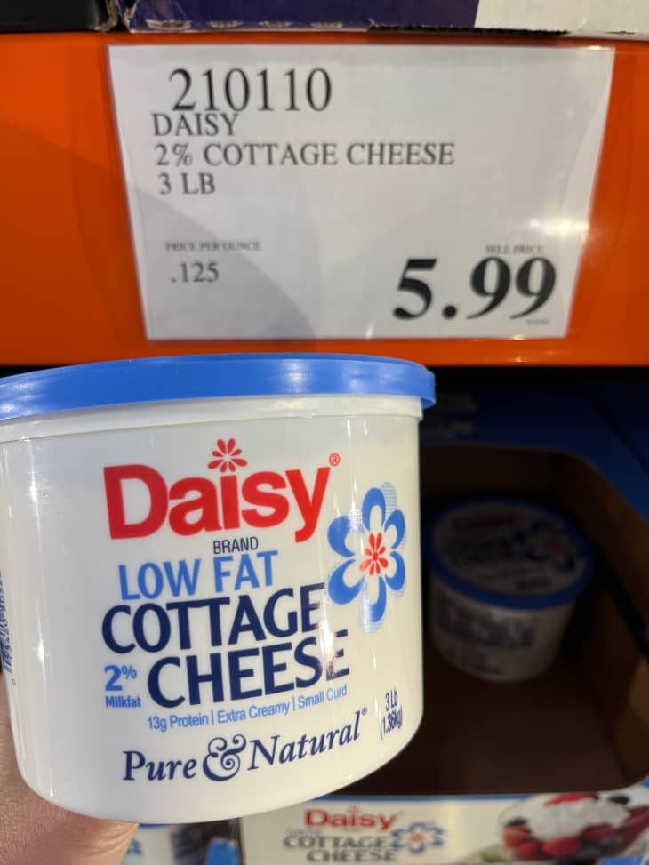 Someone holding Daisy low fat cottage cheese in Costco.