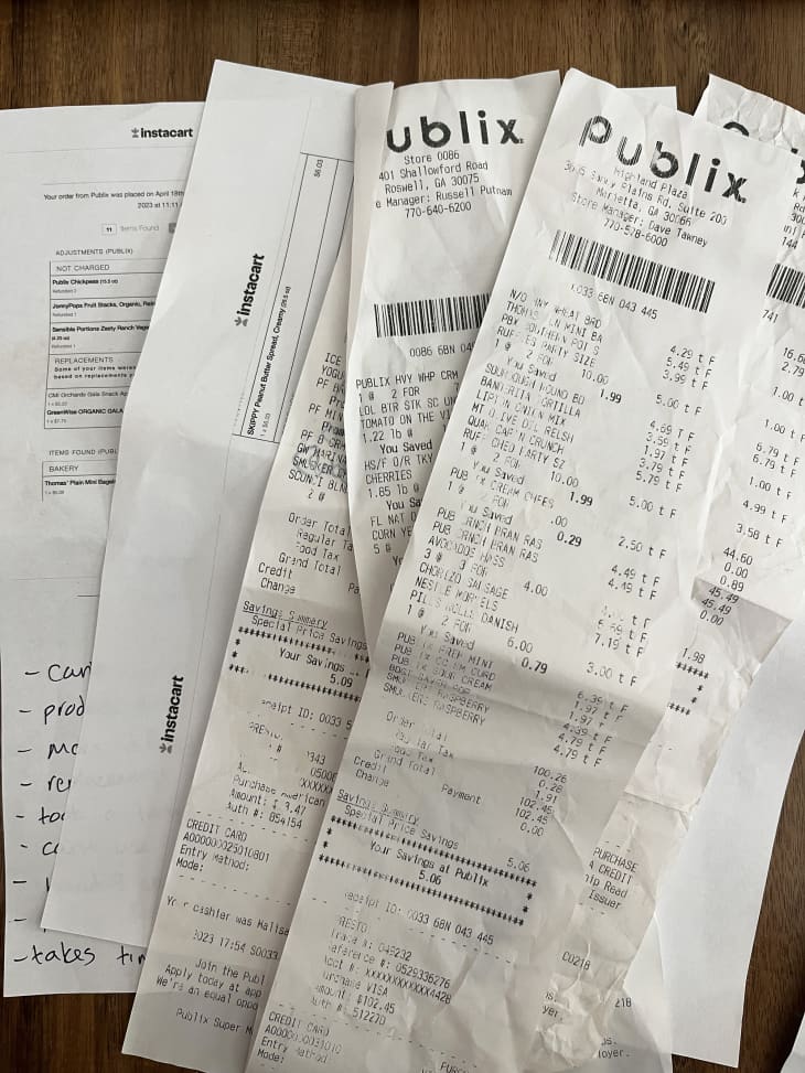 grocery receipts from publix and other stores on a wood surface