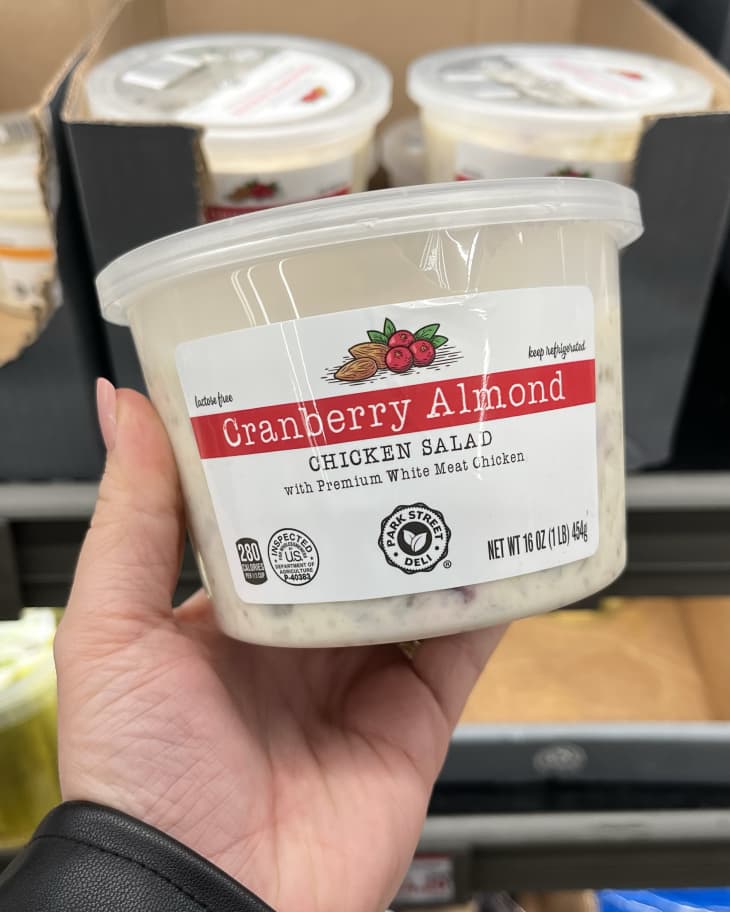 Someone holding up Cranberry Almond Chicken salad in Aldi store
