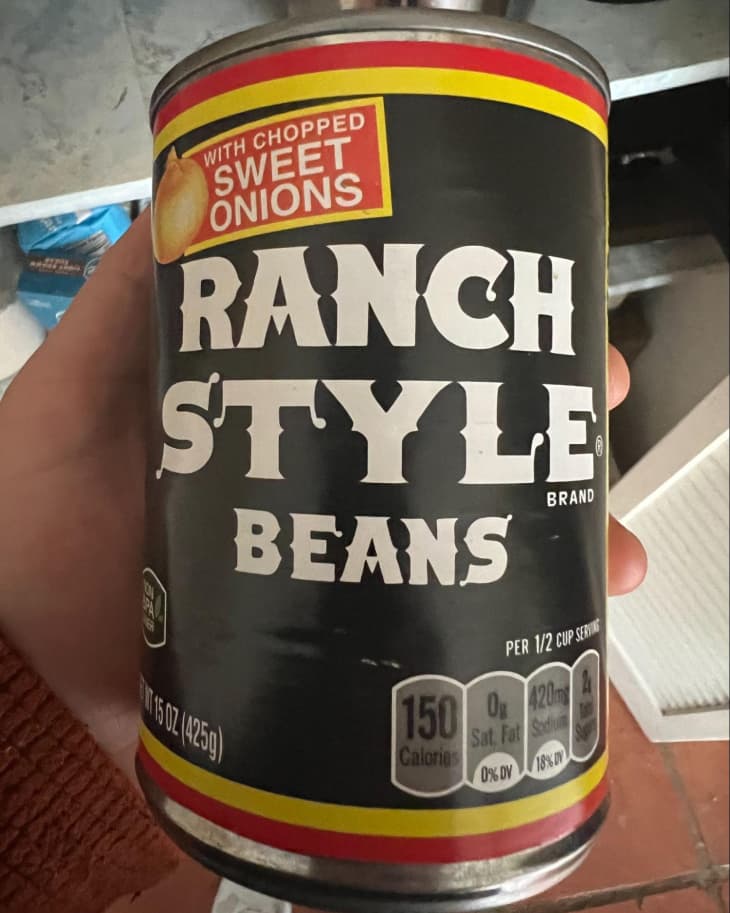 Someone holding up a can of Ranch Style Beans