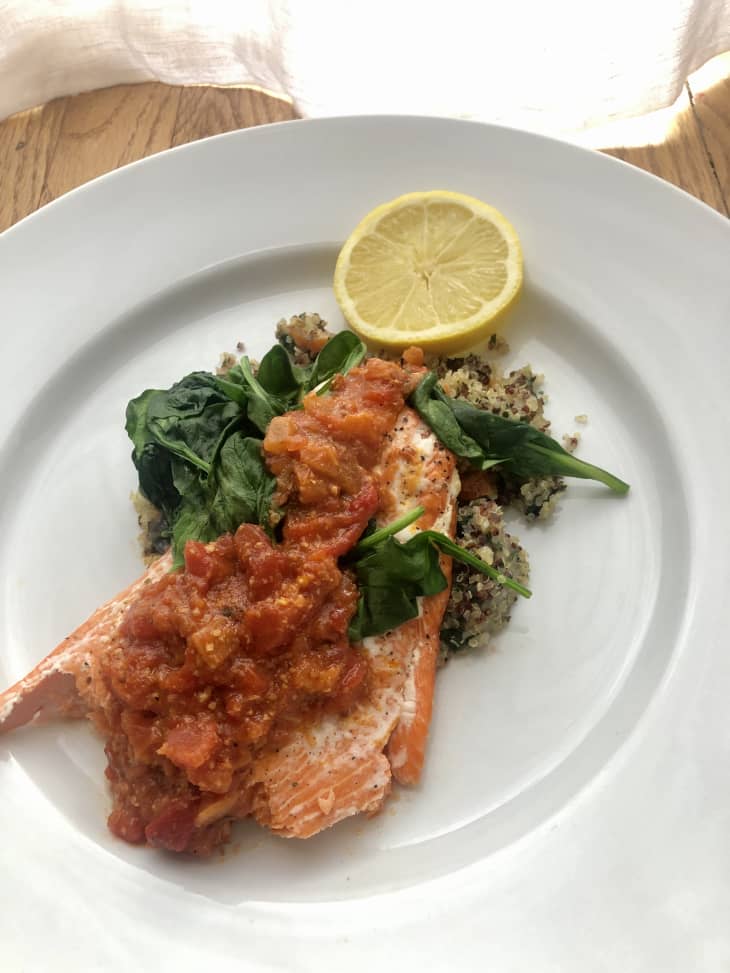 salmon with romesco sauce, spinach, and lemon