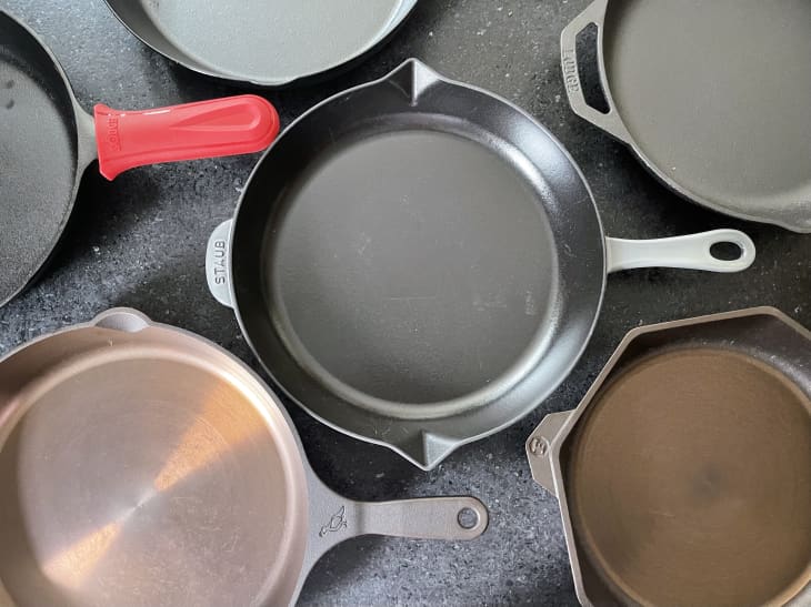 Several cast iron skillets on the countertop