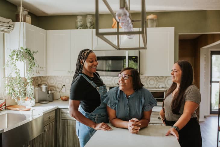 3 women in a home kitchen talking