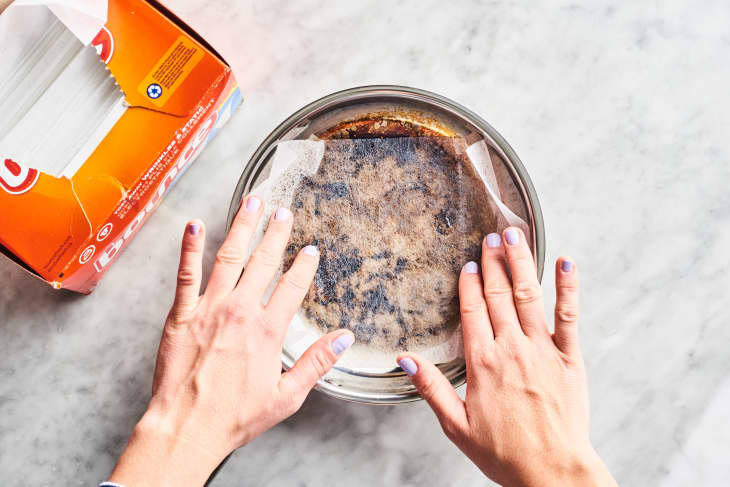 Putting dryer sheet into a burnt pan