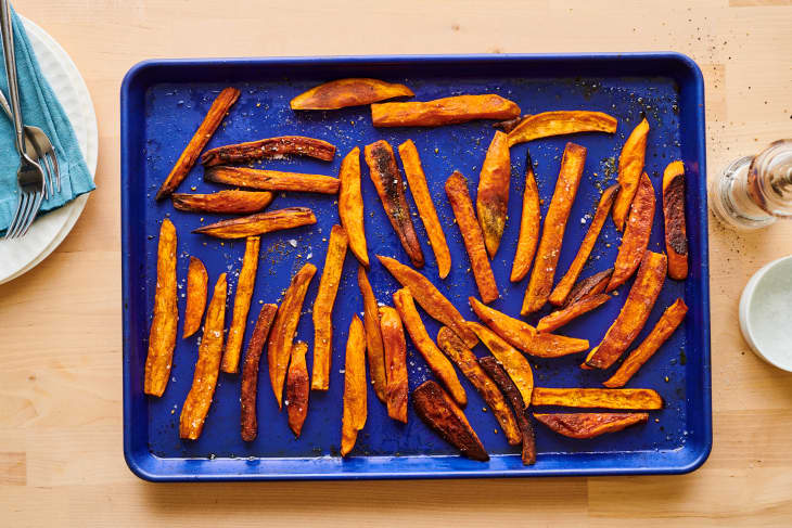 Roasted sweet potatoes on blue sheet pan