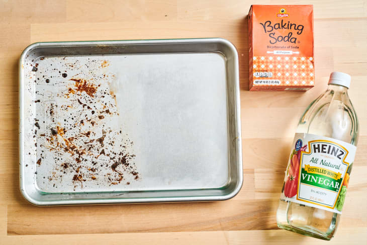 half cleaned baking sheet with baking soda and vinegar