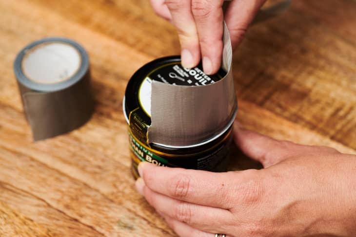 putting a piece of duct tape on a jar