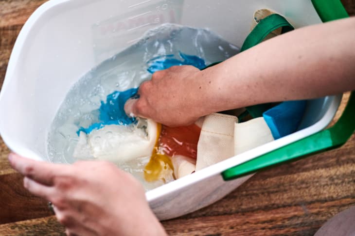 swishing around a polypropylene bag in a bucket of soapy water