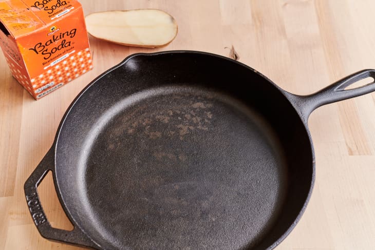 clean cast iron pan with baking soda and potato half