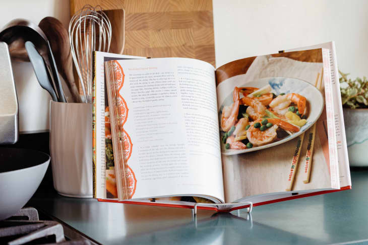 The cookbook "Stir-Frying to the Sky's Edge" opened on the kitchen counter