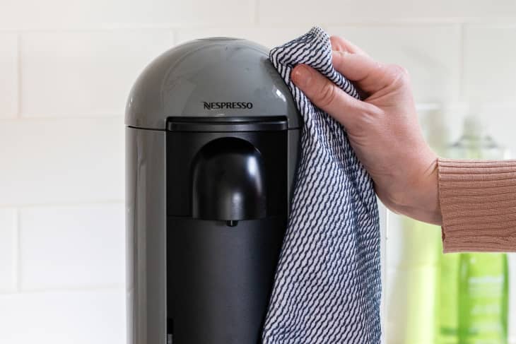 Wiping down the outside of the machine with a damp dishcloth