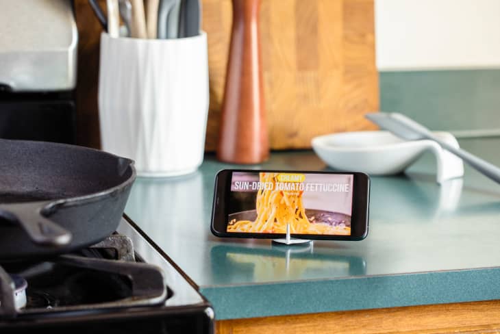 A propped up iPhone playing a food video