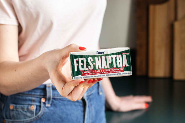 Someone holding bar of Fels-Naptha.