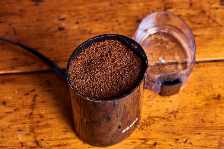coffee grinds sit in a krups coffee grinder