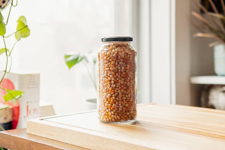 Clean jar filled with popcorn kernels and the lid on.