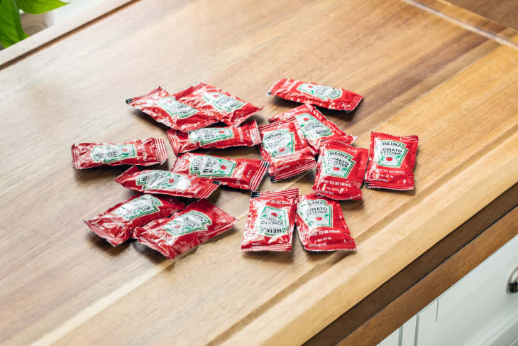 Ketchup packets on kitchen counter.