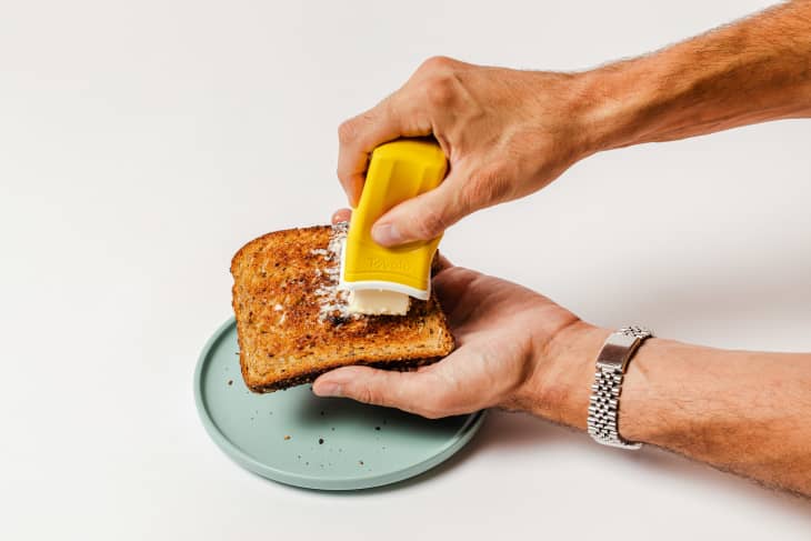 Tovolo Silicone Butter Sleeve spreading butter on toast.