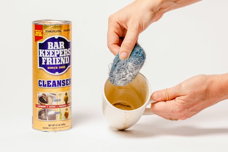 Cleaning inside of stained coffee mug with Bar Keepers Friend.