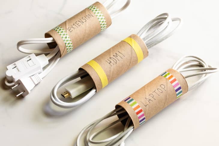 Extension cords organized in toilet paper rolls.