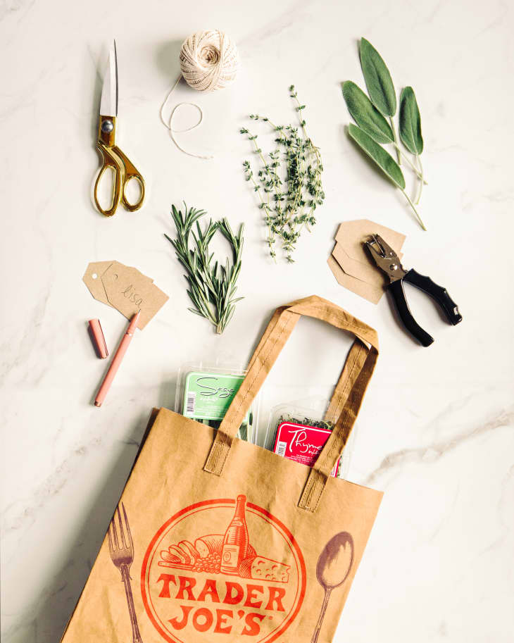 Trader Joe's bag filled with herbs and ingredients to make festive name tags