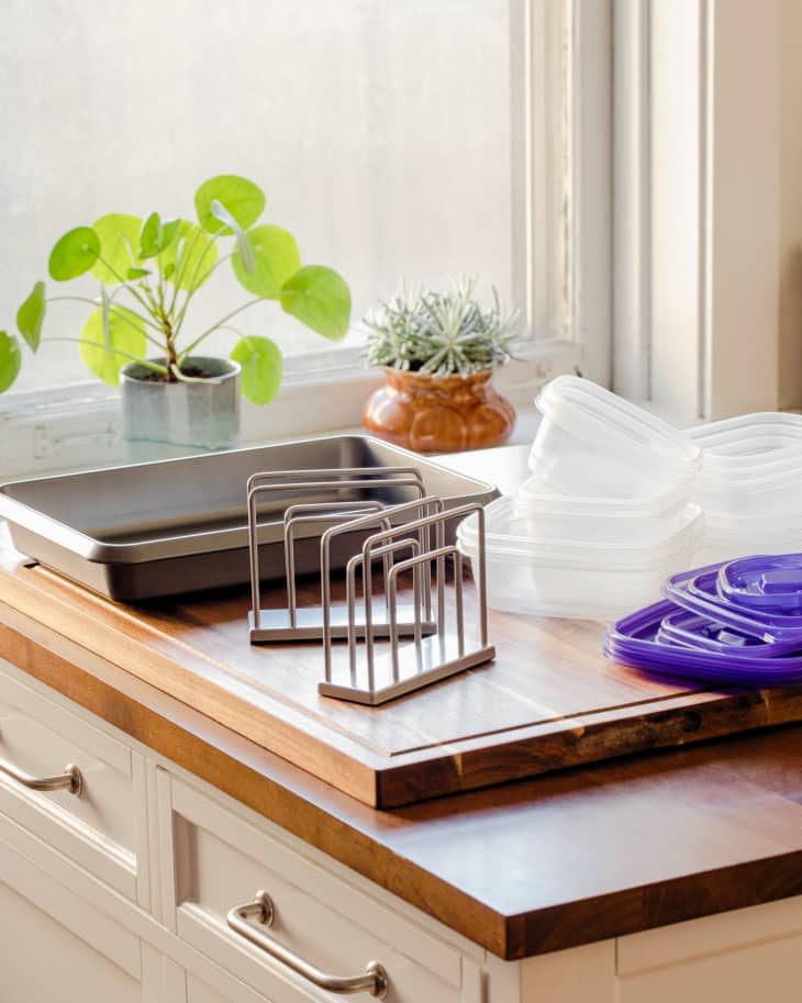 Tupperware on countertop with napkin holder.