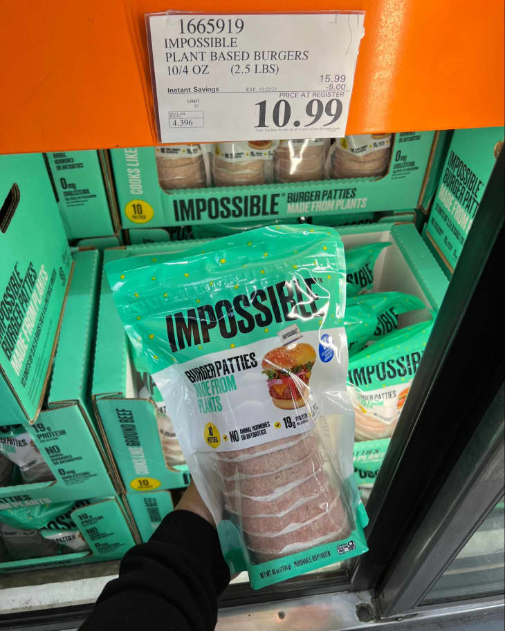 Someone holding up a package of Impossible Burger Pattiese in Costco store