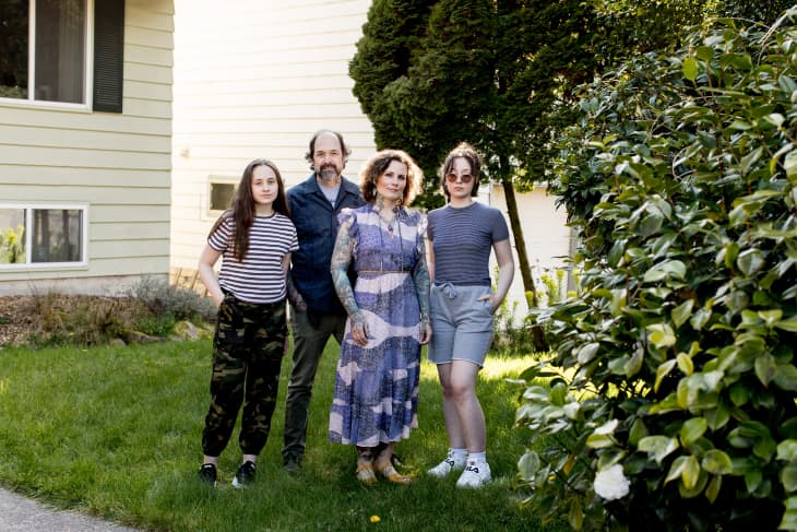 April Cornell and her family standing outside of their home